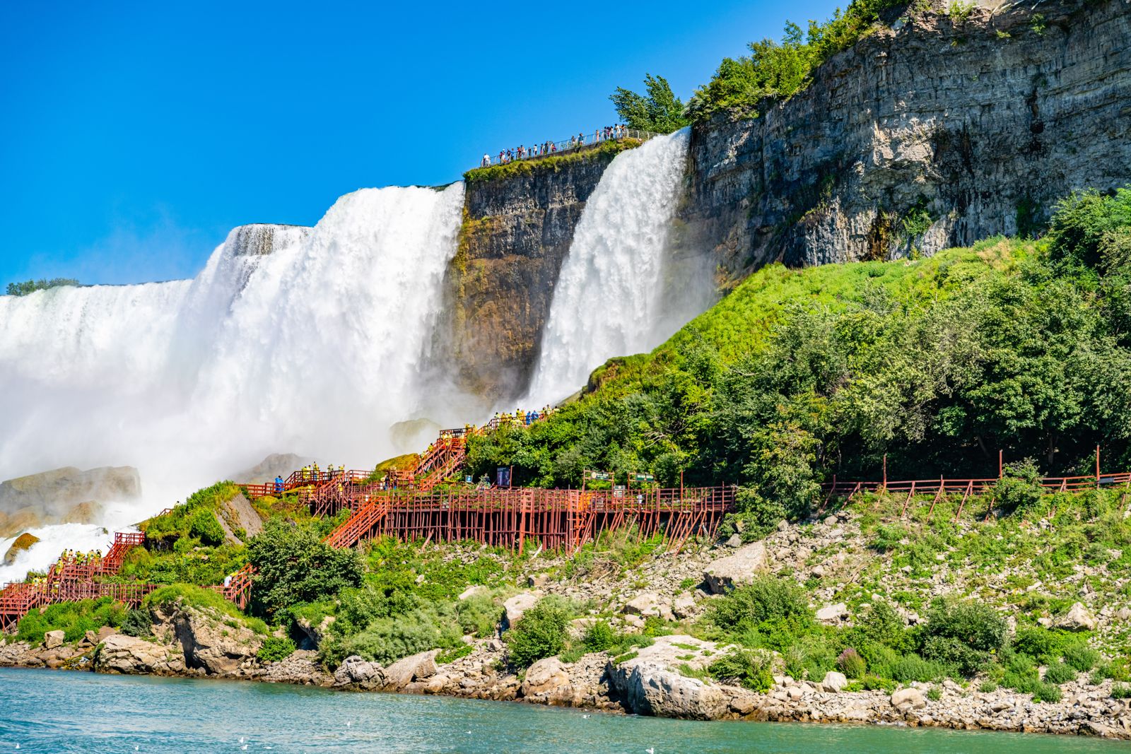 Bridal Veil Falls beside the American Falls, with red wooden walkways at its base